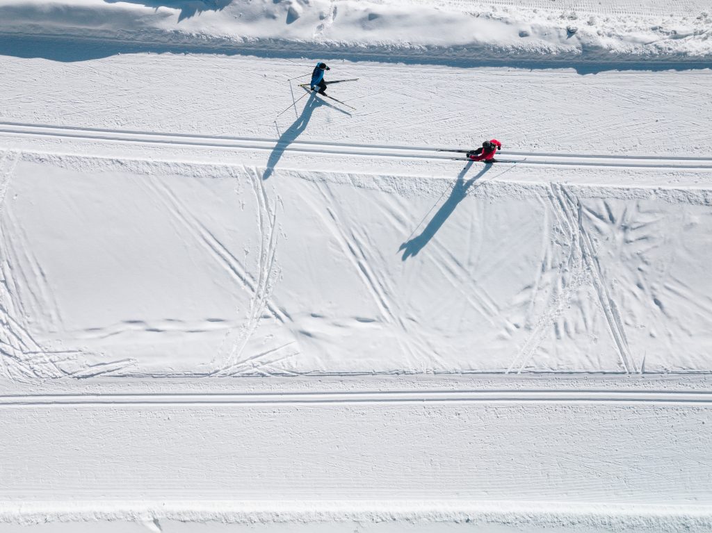 aerial view of ski tracks in snow men skiing in fi FP7H9CE