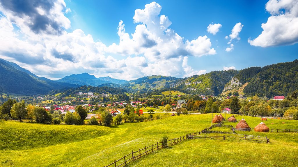 stunning alpine landscape with green fields and pi L7PNN6Y